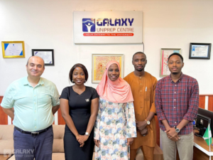 Representative from the University of Leicester, Galaxy Uniprep Managing Director, and Galaxy Uniprep staff posing together during the representative's visit to Galaxy Uniprep.